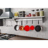 A kitchen featuring pots and pans elegantly arranged and hanging on the wall, showcasing a functional cooking space.